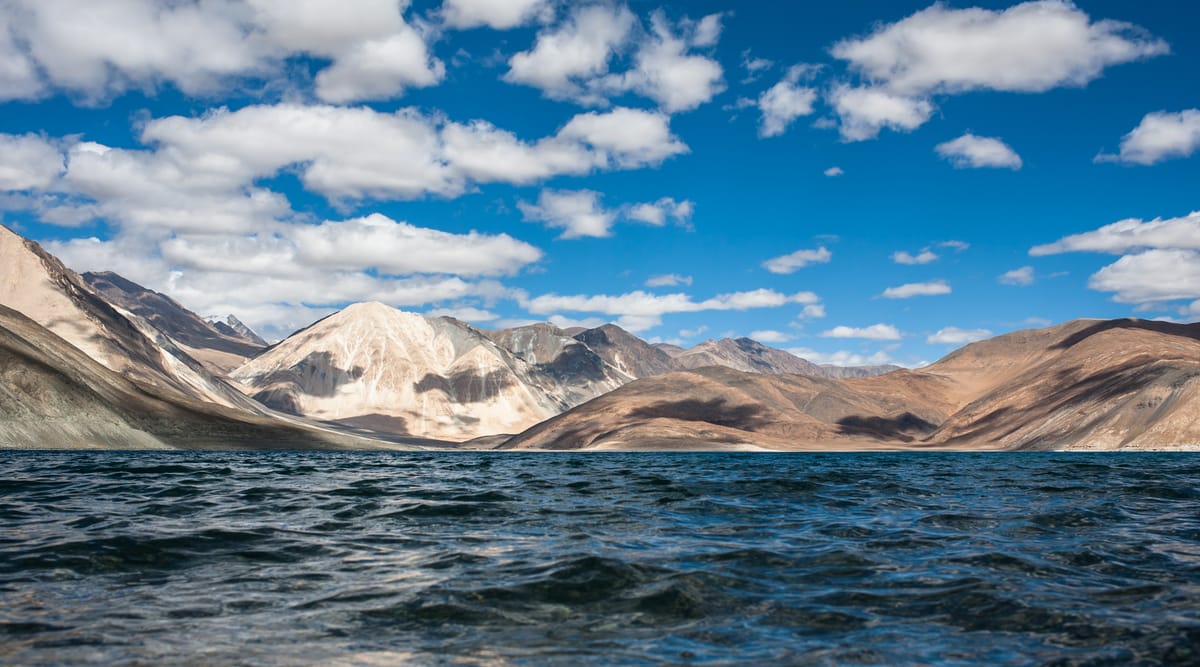 The deep blue water of Pangong Tso against bare Ladakhi mountains