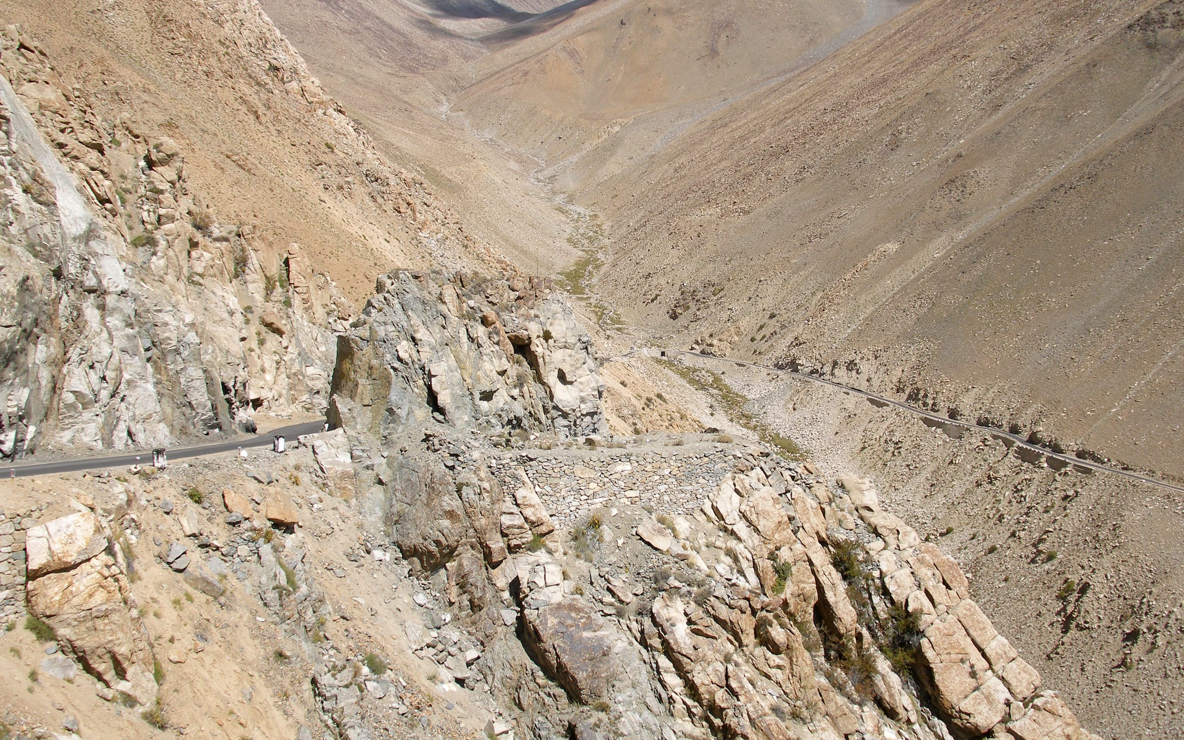 The road over Khardung La winding through bare rock in Ladakh